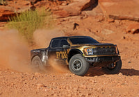 [Action] Traxxas Raptor R - çölde toz kaldıran altın-siyah RC pickup